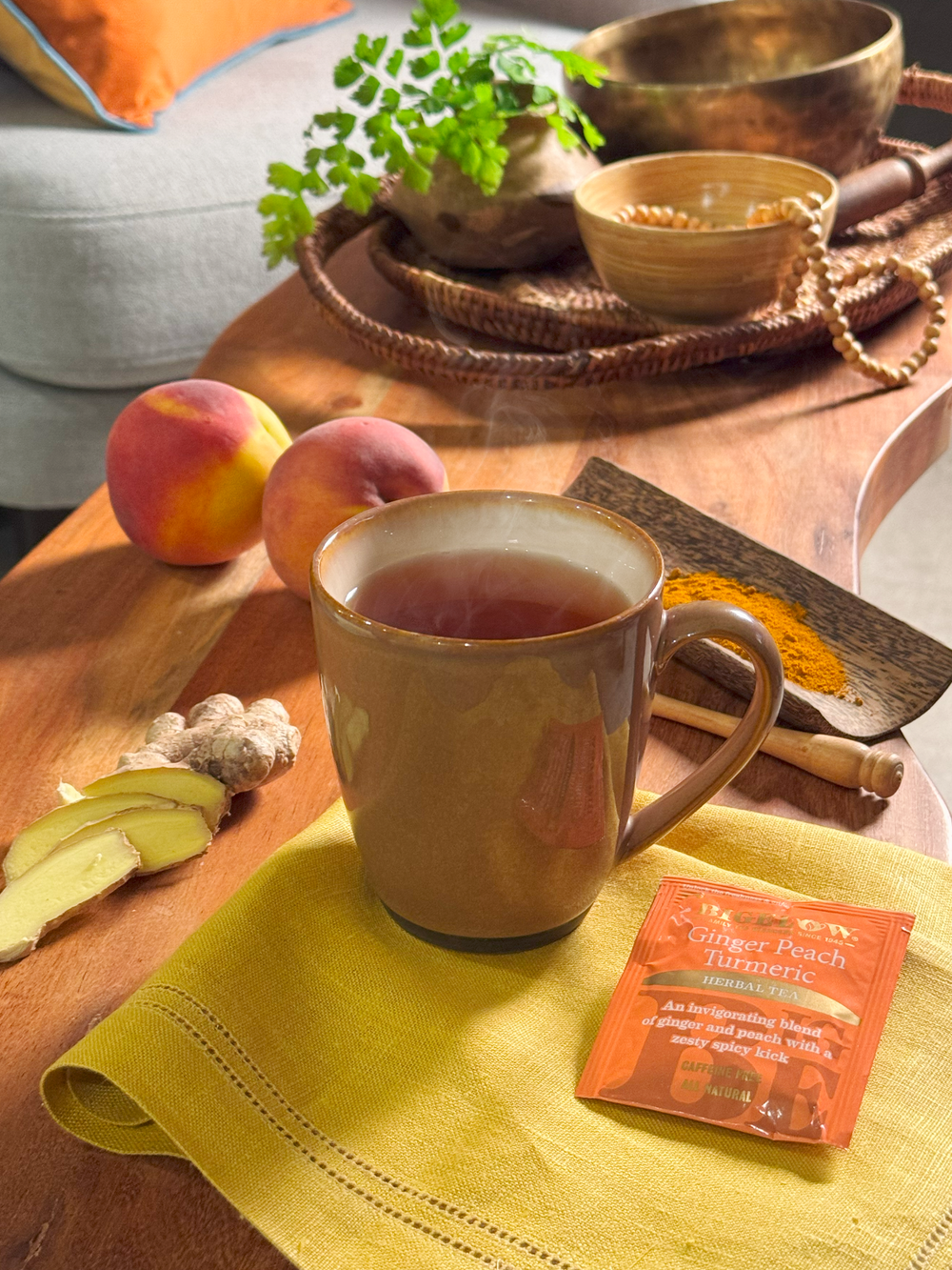 Mug of Bigelow Ginger Peach Turmeric Herbal Tea with foil packet