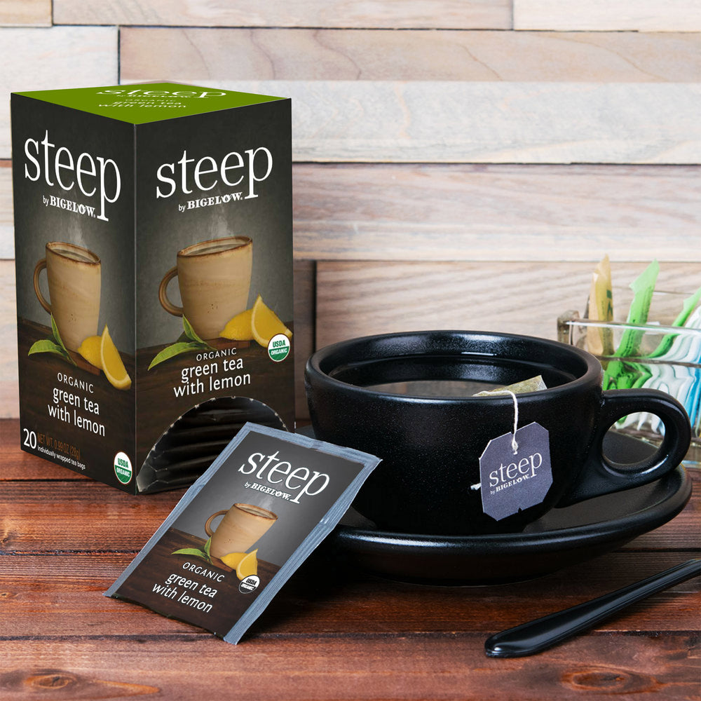 Cup and box of steep organic green tea with lemon