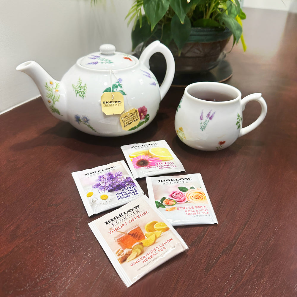 Cups of Bigelow Benefits Herbal and Green Tea boxes with ingredients